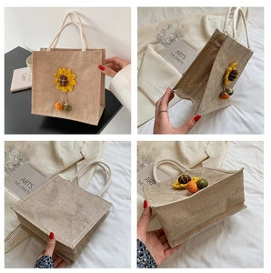 Detail of jute tote bag featuring floral sunflower design and woven rope handles