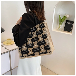 Detail showing the cartoon bear print and canvas material of the spacious tote bag