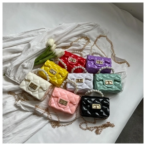 Detail showing colorful mini jelly bags with quilted texture and pearl handles