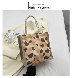 Detail of khaki linen lunch bag with heart print and thick cotton rope handles