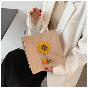 Detail of jute tote bag with yellow sunflower and soft white woven rope handles