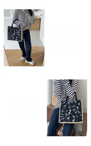 Close-up of black linen tote bag with white graffiti prints and LA logo detail