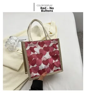 Detail of red heart patterns on a jute tote bag with soft cotton rope handles