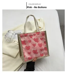 Detailed view of pink linen tote bag with heart pattern and thick white rope handles