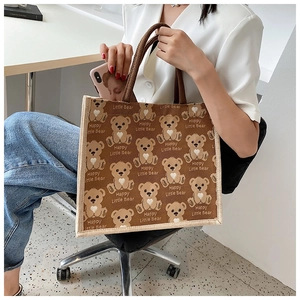 Detail of large canvas tote bag with cute bear patterns and comfortable handles