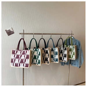 Detail view of canvas tote bags in six colors with checkerboard and rabbit patterns