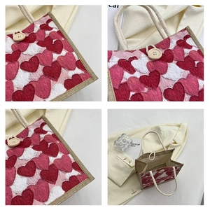 Detail of linen lunch bag showing heart patterns, wooden button, and interior space