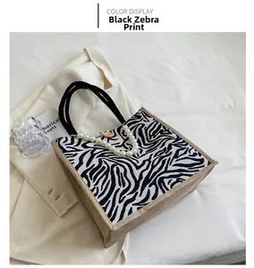 Detail of zebra pattern tote bag with pearl chain strap and golden button closure