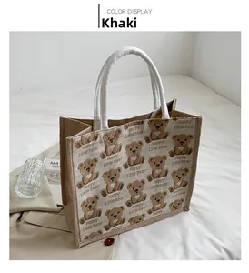 Detail of khaki jute tote bag featuring cute cartoon bear prints and rope handles