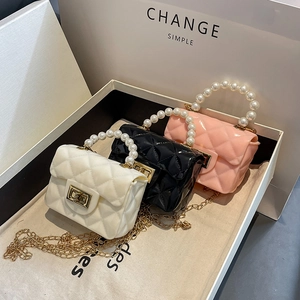 Mini jelly crossbody bags with pearl handles and quilted texture in white, black and pink