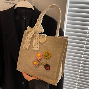 Chic beige linen tote bag with felt flower accents and rustic braided rope handles