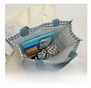 Interior view of large houndstooth tote bag showing spacious capacity for tablets and more