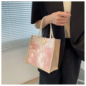 Dettaglio della borsa in lino tie-dye rosa con una grande chiusura decorativa con bottone in legno