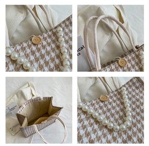 Detail view of houndstooth tote bag featuring pearl strap and rope handle accents