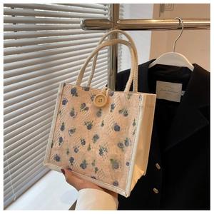 Dettaglio mini borsa in pizzo con fiori, manici in corda di canapa e chiusura con bottone