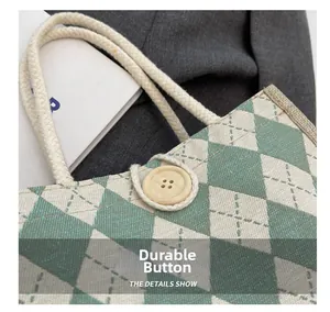 Detail of green checkerboard tote bag featuring a wooden button and cotton rope handle