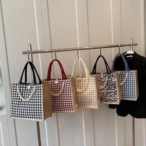 Tote bags with houndstooth and zebra patterns, pearl handles, and wood button details