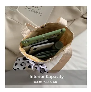 Interior storage capacity of a beige canvas tote bag with silk scarf and magnetic clasp