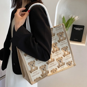Large beige canvas tote bag with brown cartoon bear pattern and rope handles