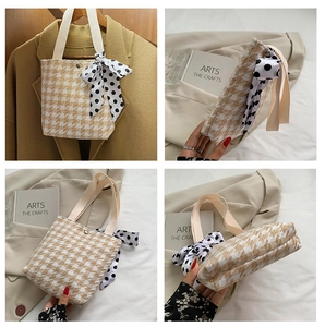 Detail of houndstooth canvas tote bag with polka dot scarf bow and golden snap button
