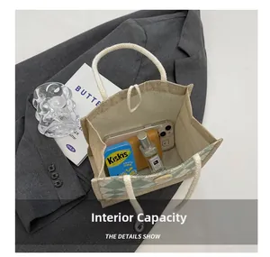 Detailed view of canvas tote bag interior showing capacity for phone and wallet