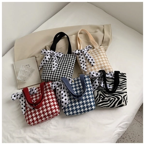 Flat lay of canvas mini tote bags in various patterns with decorative polka dot scarves