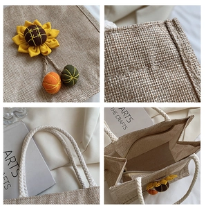 Detail of linen jute tote bag with sunflower patch, woven ball charms and cotton rope handle