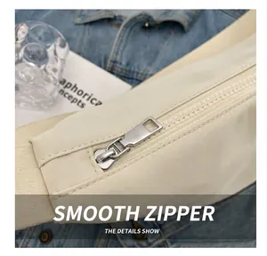 Gros plan du zip en métal sur le sac à bandoulière crème de grande capacité pour femme