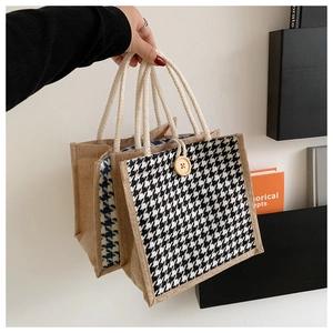 Detail of linen tote bag with houndstooth panel, wooden button, and cotton rope handles