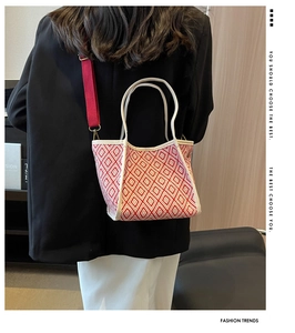 Detail showing the geometric tote with red woven pattern and detachable wide strap