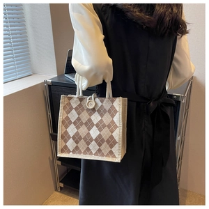 Detail of canvas tote bag showing brown argyle pattern and cotton rope handle