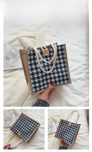 Close-up of blue houndstooth linen tote bag with rope handles and wooden buckle