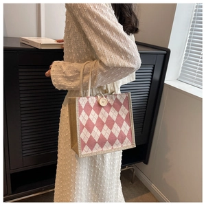 Detail of pink and white checkered canvas tote bag with rope handle and button closure