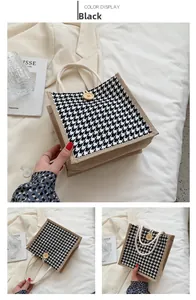 Detail of linen tote bag featuring black houndstooth pattern and wooden button buckle