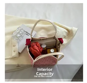 Detail view of the spacious interior of a geometric tote bag holding everyday essentials