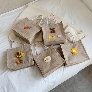 Mini jute tote bags with floral embroidery and white cotton rope handles in five patterns