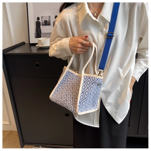 Detail of blue and white checkered pattern tote bag with adjustable canvas strap