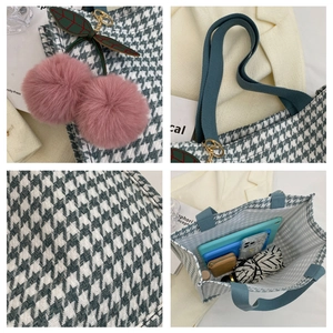 Detail of large houndstooth tote bag featuring pink cherry charm and spacious interior