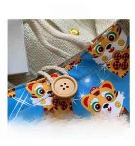 Close-up of linen tote bag with cartoon tiger print, wooden button and cotton rope handle