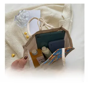 Internal storage display of linen tote showing capacity for tablet, phone, and cosmetics
