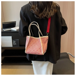 Detail of red and white lattice pattern tote bag with wide strap on a model back