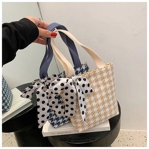 Detail of houndstooth canvas tote bags with black and white polka dot ribbon bows