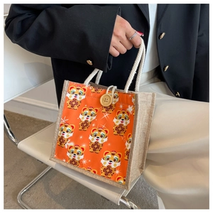Detail of cute tiger linen tote bag featuring wooden button and rope handle for daily lunch