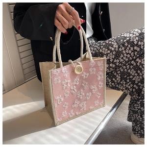 Détail du sac cabas rose avec broderie florale 3D blanche et anses en corde de coton bio