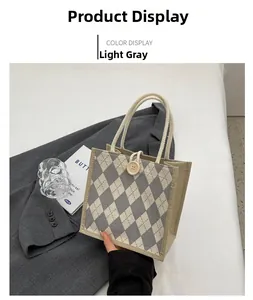 Detail of light gray argyle canvas tote bag with wooden button and cotton rope handle
