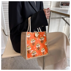 Detail of cute tiger linen tote bag with large wooden button and sturdy rope handles