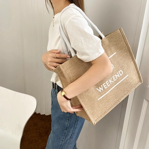 Large linen tote bag with WEEKEND print and white rope handles for daily commute