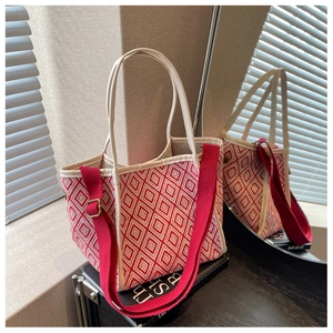 Detail of red and white geometric bucket bag with adjustable woven shoulder strap