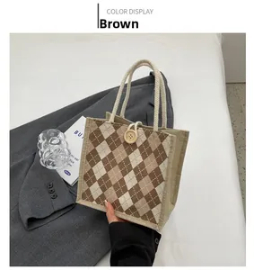 Close-up of canvas lunch bag with brown diamond pattern and wooden button closure