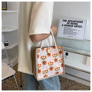 Detail of cute tiger printed linen tote bag with cream rope handle and wooden button